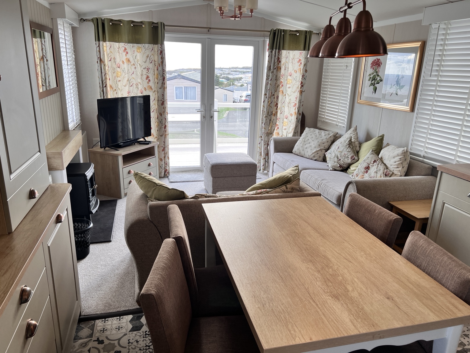 The bright living and dining space in our Devon Cliffs caravan