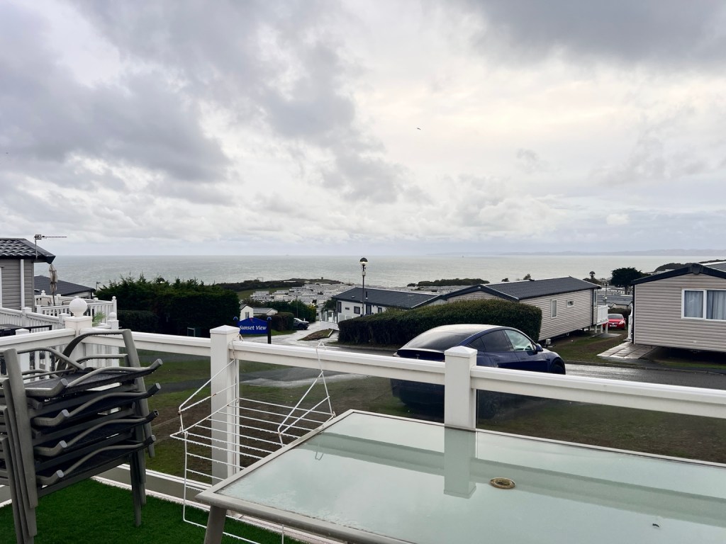 Cloudy skies over the sea and caravans at Devon Cliffs during stormy weather