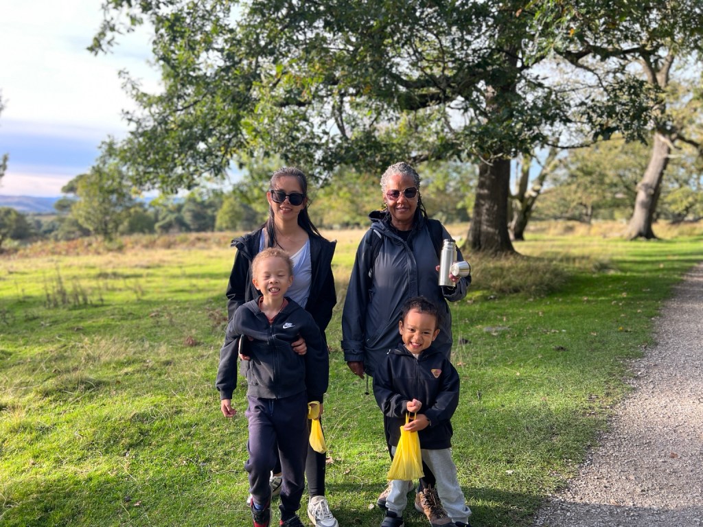 Hillary, Grandma, Oscar and Casey standing together beneath the trees at Longshaw Estate.