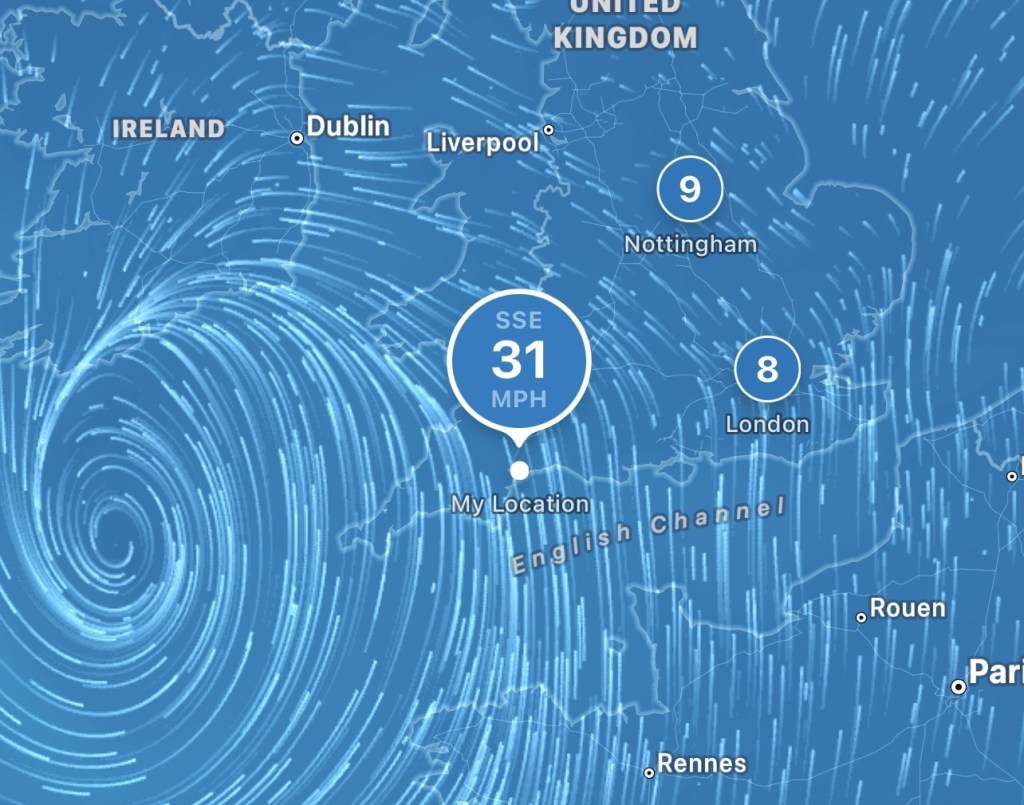Wind map showing a large swirling storm system southwest of Cornwall and Devon, with a 31 mph wind reading near Devon Cliffs.
